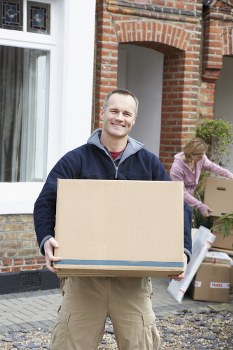 Removal team loading boxes for a UK moving service