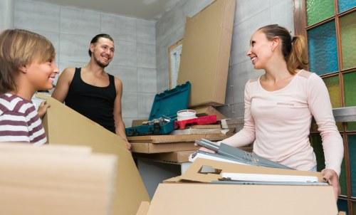 Professional movers handling flat removals in Bow with careful packing