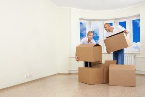 Urgent home moving service with boxes and packed belongings in Bow