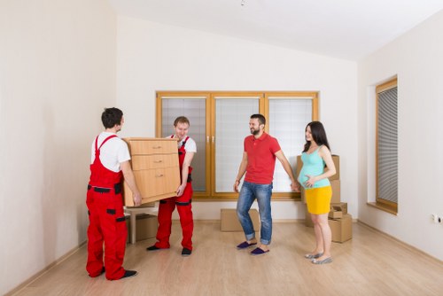 Careful packing materials and boxed household items ready for moving in Bow