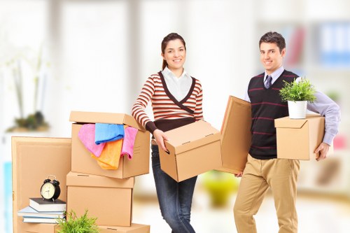Professional man and van loading furniture for transport in Bow
