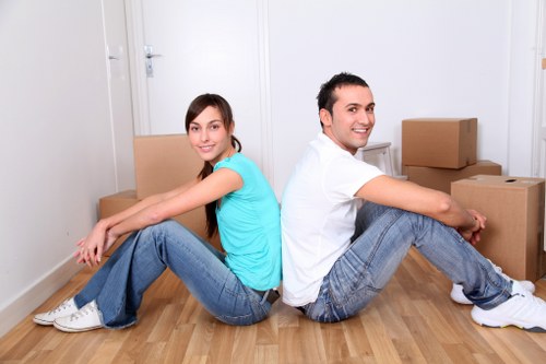 Local packing team carefully wrapping fragile household items in Bow