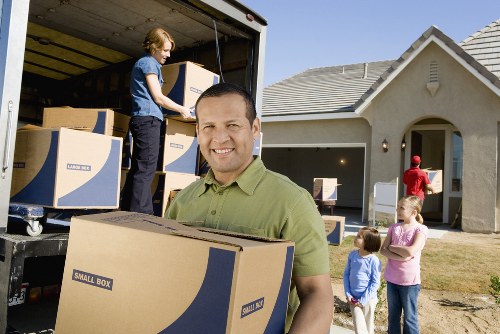 Workers assessing risks before a house removal and preparing equipment